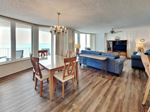 a living room with a dining room table and a couch at Shores Club 807 in Daytona Beach