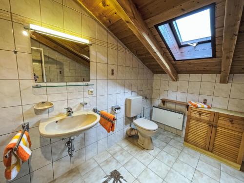 a bathroom with a sink and a toilet and a window at Holiday Home Mühlberg by Interhome in Holzhammer