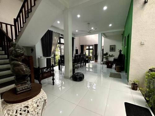 a large living room with a staircase and a living room at Moonbeam Villa in Colombo