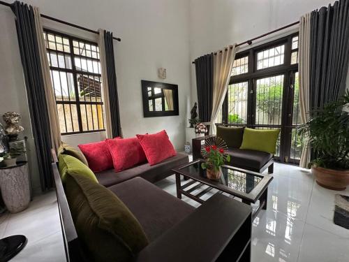 a living room with a couch and a table at Moonbeam Villa in Colombo
