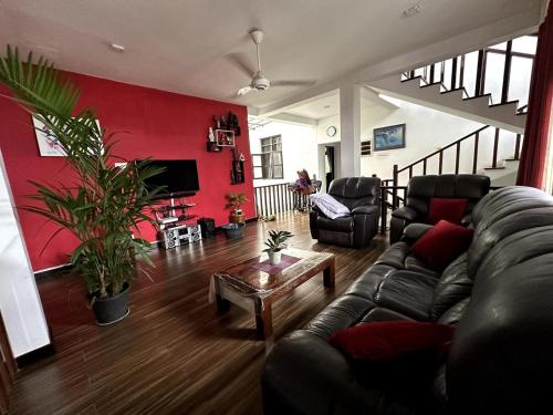 a living room with a couch and a table at Moonbeam Villa in Colombo