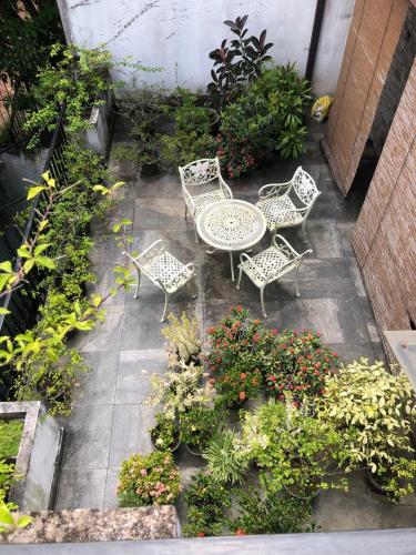 a patio with a table and chairs and plants at Moonbeam Villa in Colombo