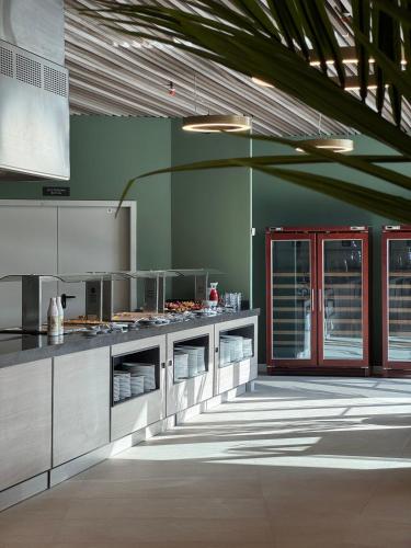 a large kitchen with stainless steel appliances in a building at Hotel BCL Podium La Nucia in La Nucía