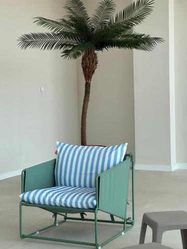 a palm tree in a room with a bench and a palm tree at Hotel BCL Podium La Nucia in La Nucía