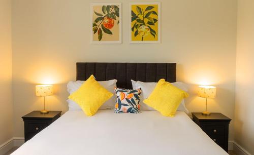a bedroom with a white bed with two lamps at Cornflower in Edlington