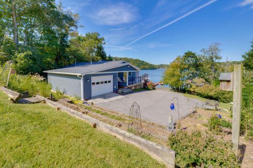 an overhead view of a small house with a driveway at Radford Home with Wraparound Deck! in Radford