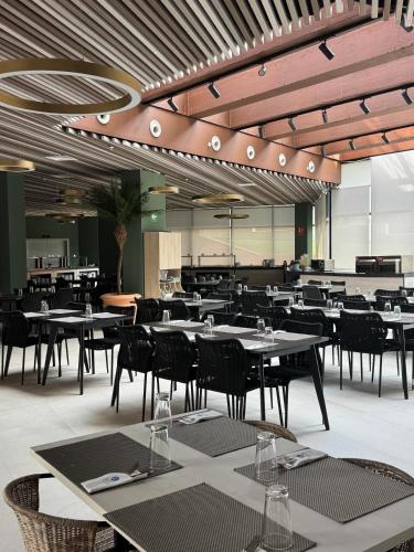 an empty dining room with tables and chairs at Hotel BCL Podium La Nucia in La Nucía