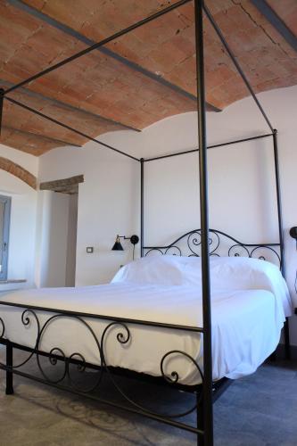 a bedroom with a metal bed with white sheets at Alfredo Romano in Poggioferro