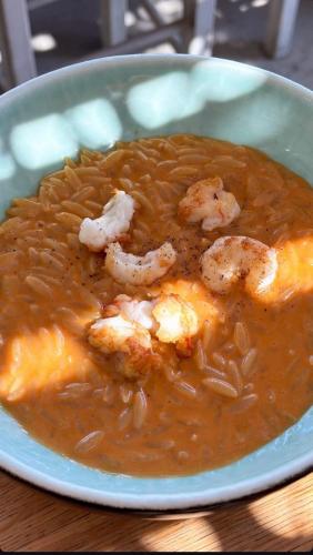 a bowl of food with shrimp in a soup at Sifnos Blue Horizon House - Endless Blue in Apollonia