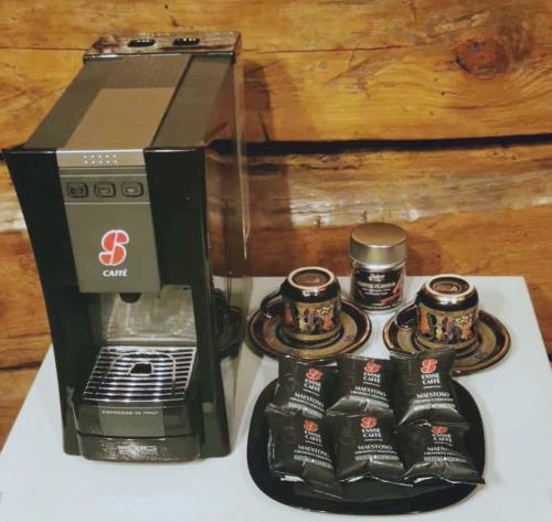 a coffee maker with coffee cups on a table at Casa33 in Dobrovnik