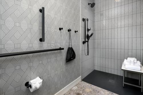 a bathroom with a shower with a toilet and a sink at The Artful Way Hotel in Asheville