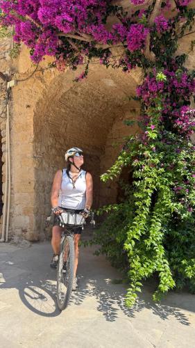 a man riding a bike through a tunnel with flowers at Mar Blau Estartit Rental in L'Estartit
