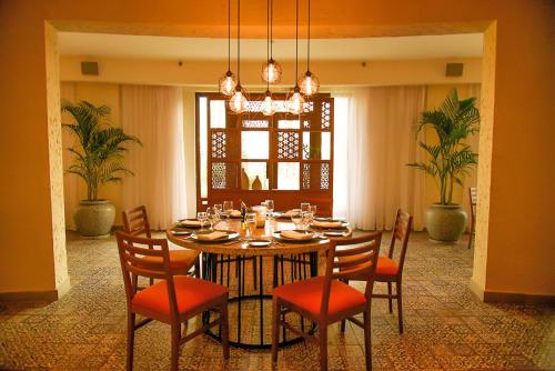 a dining room with a table with chairs and a chandelier at JAZ Fanara Resort in Sharm El Sheikh