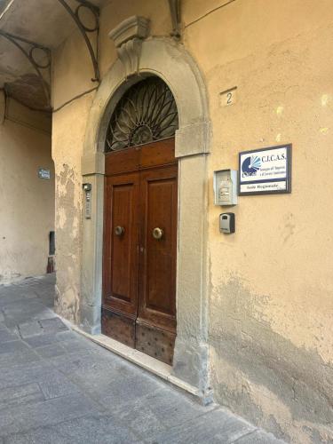 a wooden door on the side of a building at Agorà in Umbertide