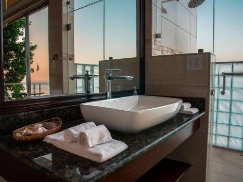 a bathroom with a sink with towels on a counter at The Pearl Suite in La Chumicosa