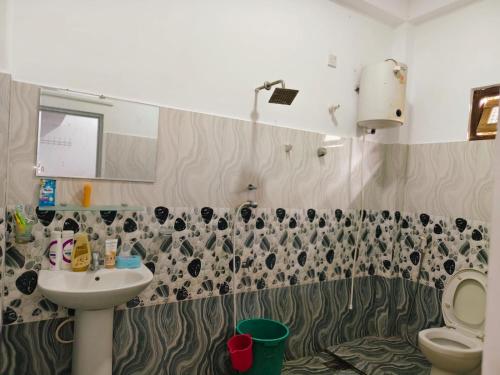 a bathroom with a sink and a toilet at TR Rest House in Trincomalee