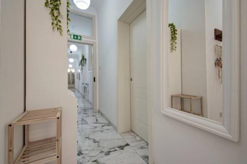a hallway with white walls and a marble floor at Casa Elena, Private Garden, Office,1 Minute to the Sea by Haven & Keys Malta in Sliema