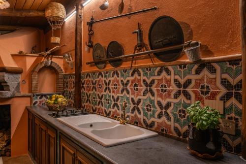 a kitchen with a sink and plates on the wall at Villa Caruso with Private Pool in Sorrento