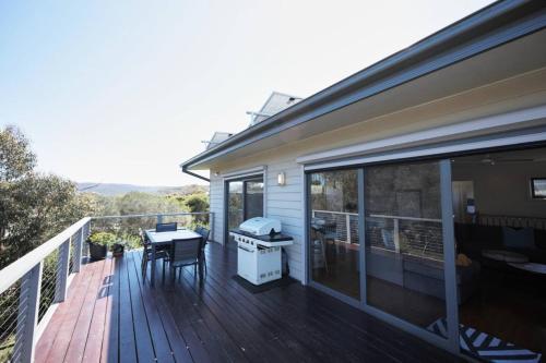 a deck with a table and a grill on a house at Aireys Nest in Aireys Inlet