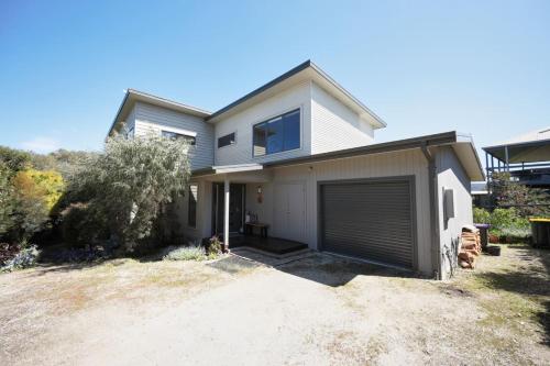a white house with a large garage at Aireys Nest in Aireys Inlet