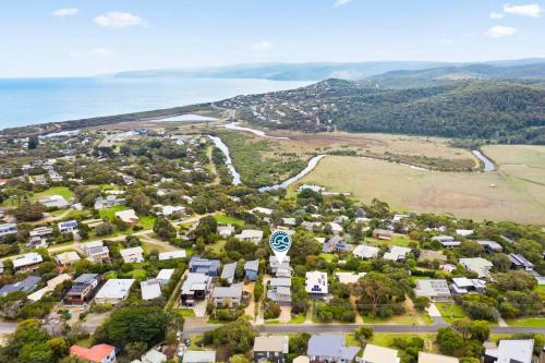 an aerial view of a town with the ocean at Aireys Nest in Aireys Inlet