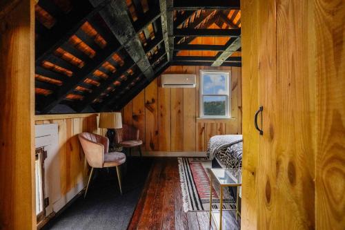 a room with a bed and a table and a chair at Charming 2BR with Fire Pit on Farm - 10 Min to Wharf in Onancock