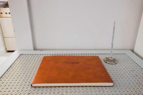 a brown book on the floor in a room at Sweet 1BDR Farm Cottage with Fire Pit and Creek View in Hacksneck