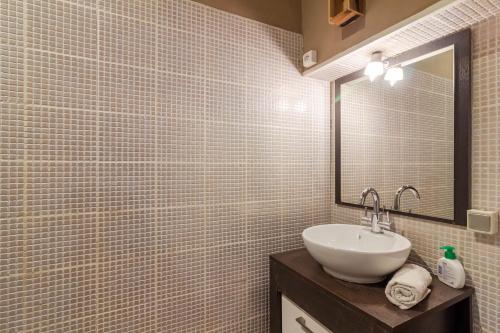 a bathroom with a sink and a mirror at Villa Les Touilles - Dordogne in Piégut-Pluviers