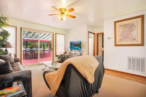 a living room with a ceiling fan and a couch at Spacious 3BR with Dock on Working Farm with Pool Table in Hacksneck