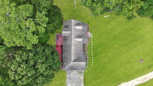 an aerial view of a building in a field at Spacious 3BR with Dock on Working Farm with Pool Table in Hacksneck