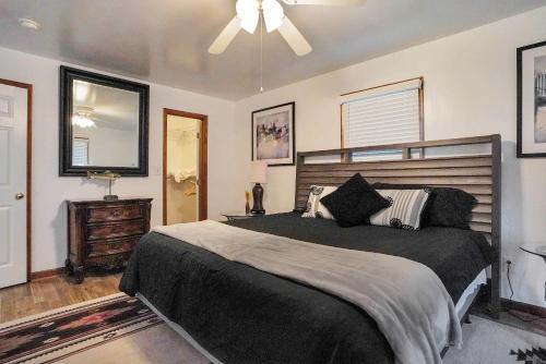 a bedroom with a large bed and a ceiling fan at Spacious 3BR with Dock on Working Farm with Pool Table in Hacksneck