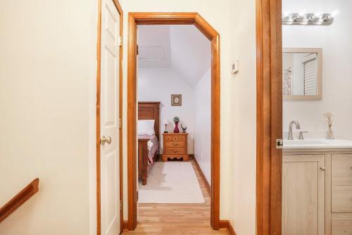 a hallway with a sink and a mirror at Spacious 3BR with Dock on Working Farm with Pool Table in Hacksneck