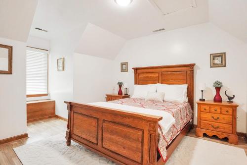 a bedroom with a large wooden bed and a window at Spacious 3BR with Dock on Working Farm with Pool Table in Hacksneck