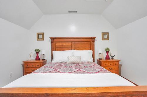 a bedroom with a large bed and two night stands at Spacious 3BR with Dock on Working Farm with Pool Table in Hacksneck