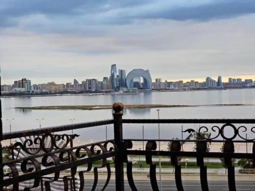 a bench with a view of a city and a body of water at Crown Suites in Baku