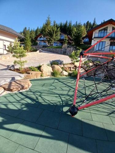 a small airplane is sitting on a golf course at EcoBerghaus - Котеджне містечко in Bukovel