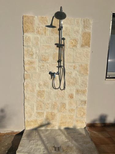 a light hanging from a brick wall at CasaMè - Villa Castelli in Villa Castelli