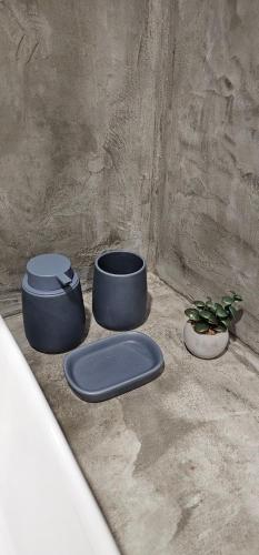 three pots sitting on the ground with a plant at Spiti Studio City Center in Rhodes Town