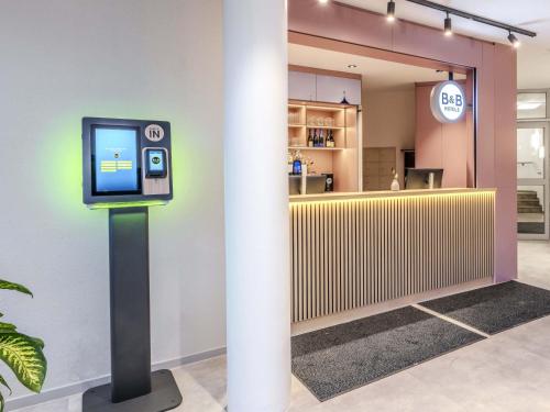 a pay station in a lobby with a counter at B&B HOTEL Passau-Süd in Passau