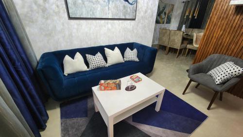 a living room with a blue couch and a table at Santiago Family-Friendly in Pontezuela Arriba