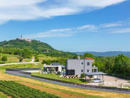a house with a hill in the background at Villa Tia in Kukurini - Haus für 8 Personen in Pićan