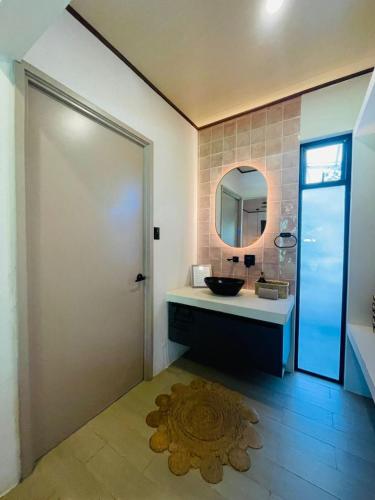 a bathroom with a sink and a mirror at Tropical Private Home for 8pp with pool in Talamanca