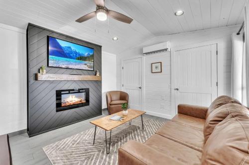 a living room with a couch and a fireplace at This is IT Cabin with a hot tub fire pit & indoor pool in Bryant