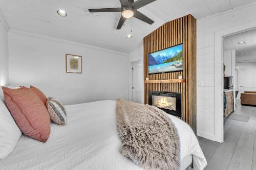 a bedroom with a bed with a fireplace and a tv at This is IT Cabin with a hot tub fire pit & indoor pool in Bryant