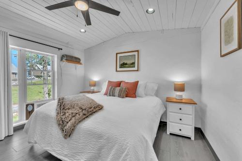 a bedroom with a bed and a ceiling fan at This is IT Cabin with a hot tub fire pit & indoor pool in Bryant
