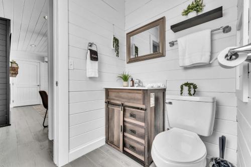 a bathroom with a toilet and a sink at This is IT Cabin with a hot tub fire pit & indoor pool in Bryant