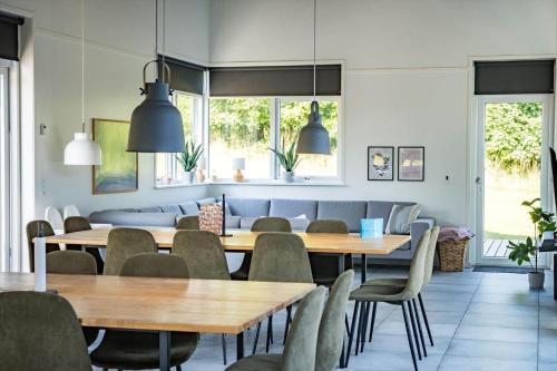 a dining room with wooden tables and chairs at 8567-Grenaa-Sletten-106 in Fuglsang