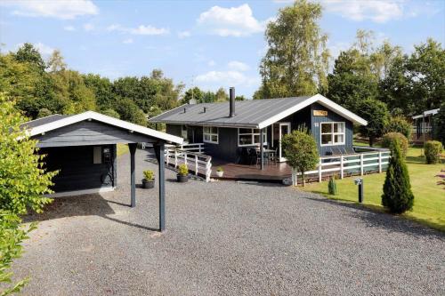 a house with a garage in front of it at 8960-Orsted-Ternevej-15 in Kare