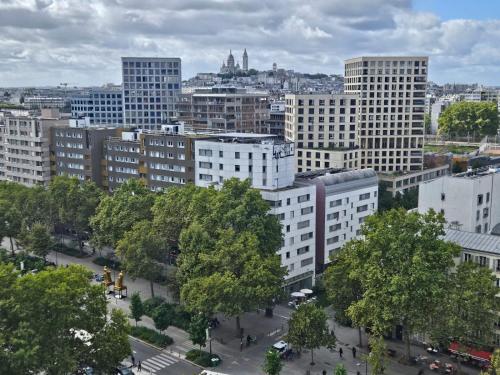 a view of a city with trees and buildings at A Paris in Paris