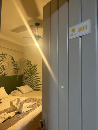 a room with a bed with a sign that reads at Pousada Villa Guimaraes in Chapada dos Guimarães